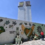 Article thumbnail: People gather in front of the makeshift memorial created on the wall surrounding Grenfell tower in west London, on June 14, 2022, on the fifth anniversary of the tragedy. - The names of the 72 people who perished in Britain's worst residential fire since World War II were read out on June 14, 2022 at a church service marking the fifth anniversary of the blaze. Survivors and families of the victims of the Grenfell Tower fire gathered at Westminster Abbey for the first of a day of events to remember the tragedy. (Photo by Glyn KIRK / AFP) (Photo by GLYN KIRK/AFP via Getty Images)