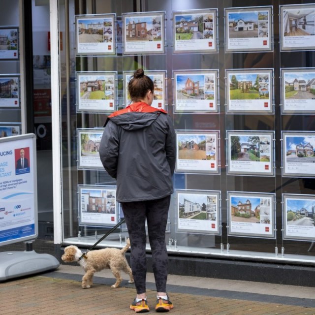 Article thumbnail: Woman looking in the window at properties advertised in the window of an estate agent on 29th May 2024 in Macclesfield, United Kingdom. Macclesfield is a market town and civil parish in the authority of Cheshire East. Housing in the UK is a very important contributing factor and measure in the economy as house prices and the property market continues to rise, pricing many people of lower incomes out of owning their own homes. (photo by Mike Kemp/In Pictures via Getty Images)