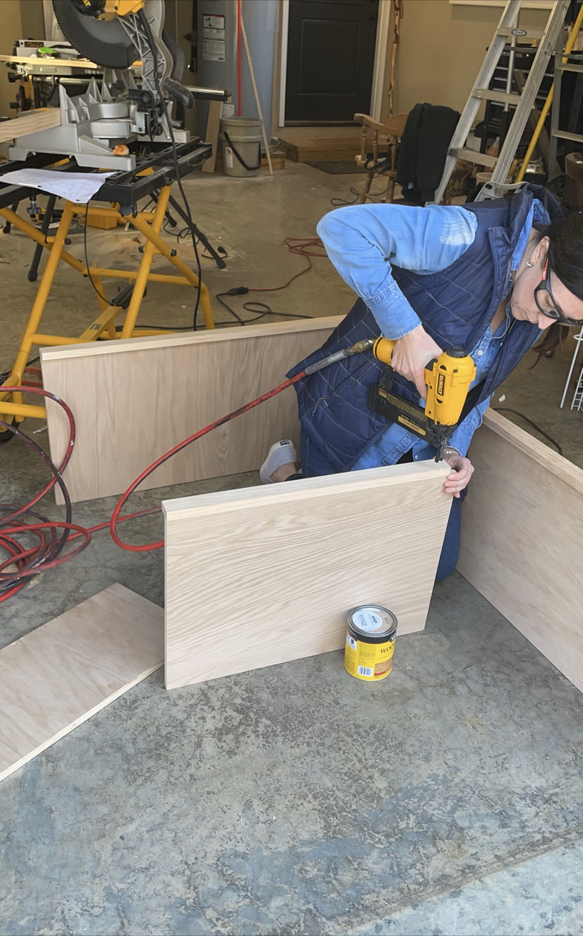 lady nailing wood shelf together