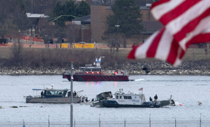 A diving team and police boat is seen around a wreckage site in the Potomac River from Ronald Reagan Washington National Airport, Thursday, Jan. 30, 2025, in Arlington, Va. (AP Photo/Jose Luis Magana)