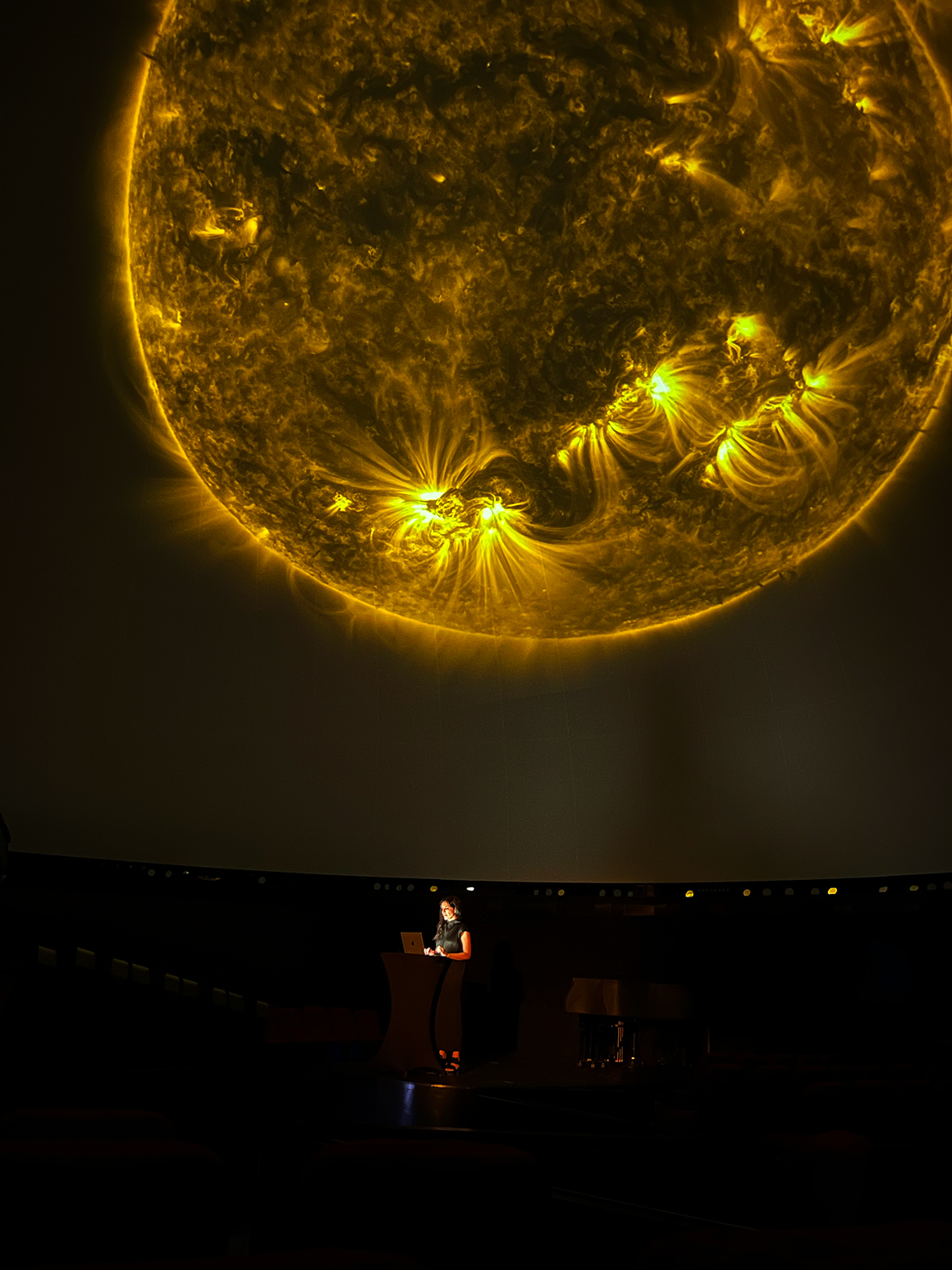 Ala Roushan presenting her “Solar Exchange” lecture performance, Hamburg Planetarium, Germany, June 20, 2024.