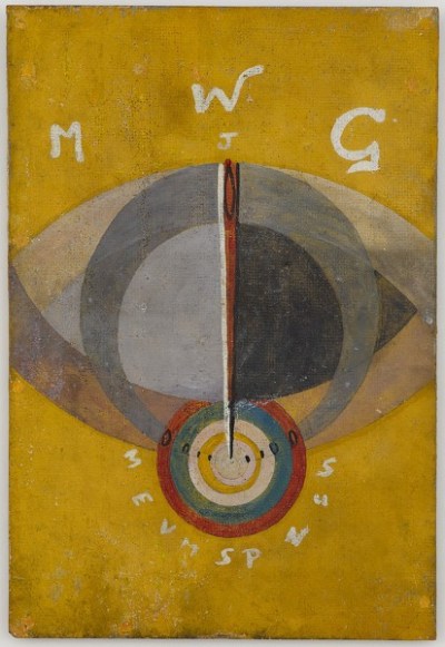 A painting of an eye with a spear inset in its iris. The spear touches a the center of a multicolored target. Above the eye are the letters 'M W G J,' and below the target are 'MEVMSPNUS.'