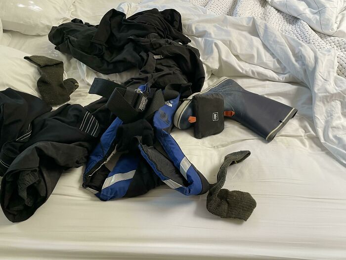 Messy bed with clothes and boots scattered, illustrating infuriating habits of boyfriends and husbands.