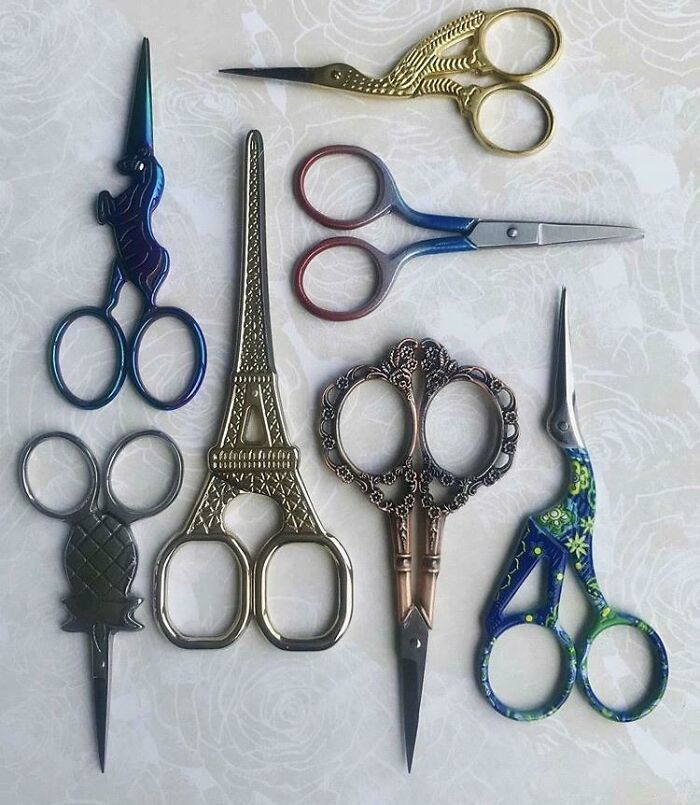 Unique collections of intricate novelty scissors arranged creatively on a patterned background.