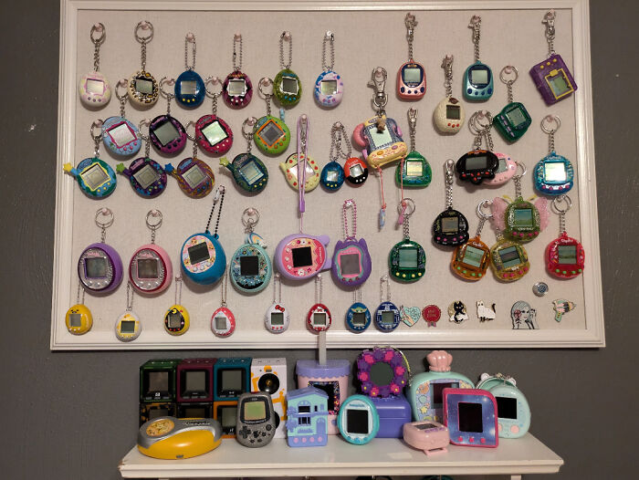 Unique collections of vintage Tamagotchis displayed on a board and shelf.