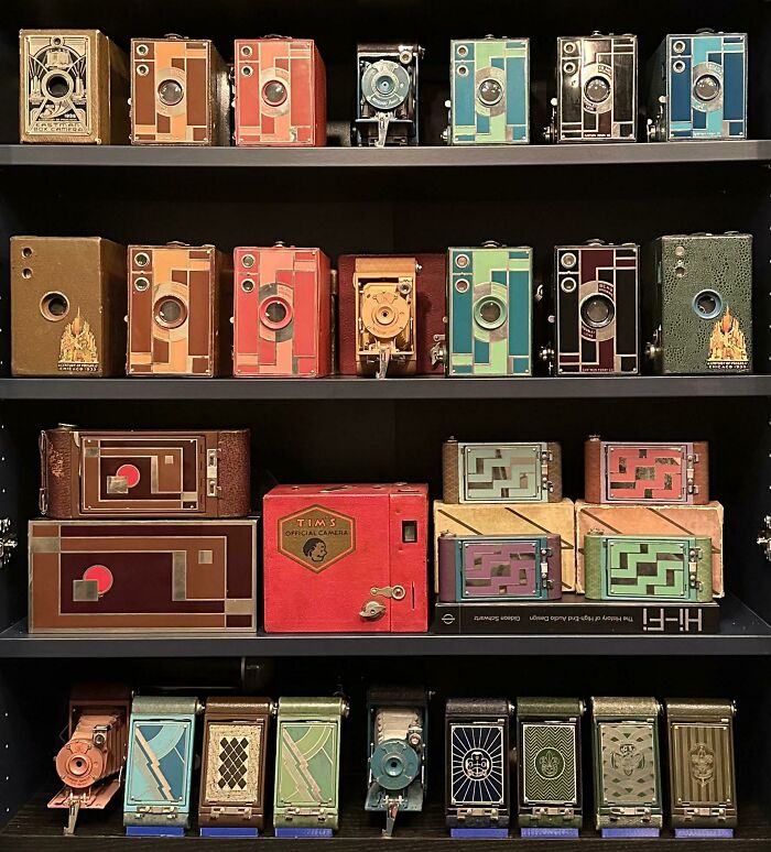 Shelf displaying unexpected unique collections of vintage cameras in various vibrant colors and designs.