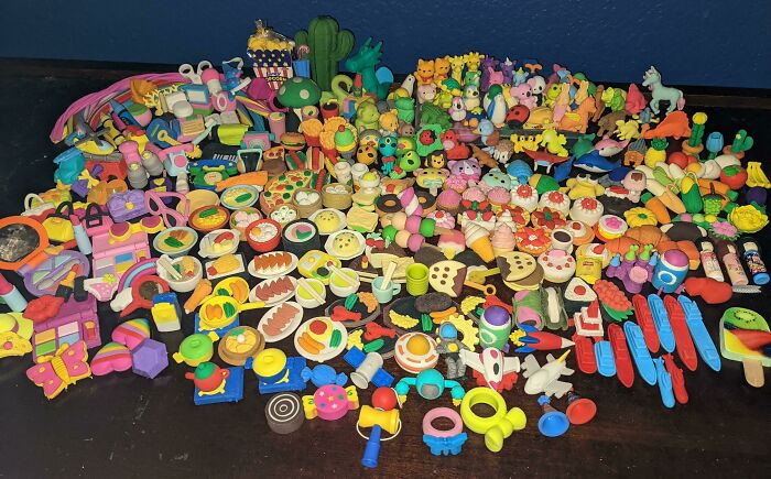 Collection of colorful erasers in various shapes, showcasing unexpected unique collections on a dark surface.