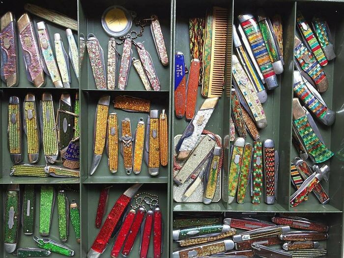 Various colorful pocket knives arranged in a display, representing unexpected unique collections.