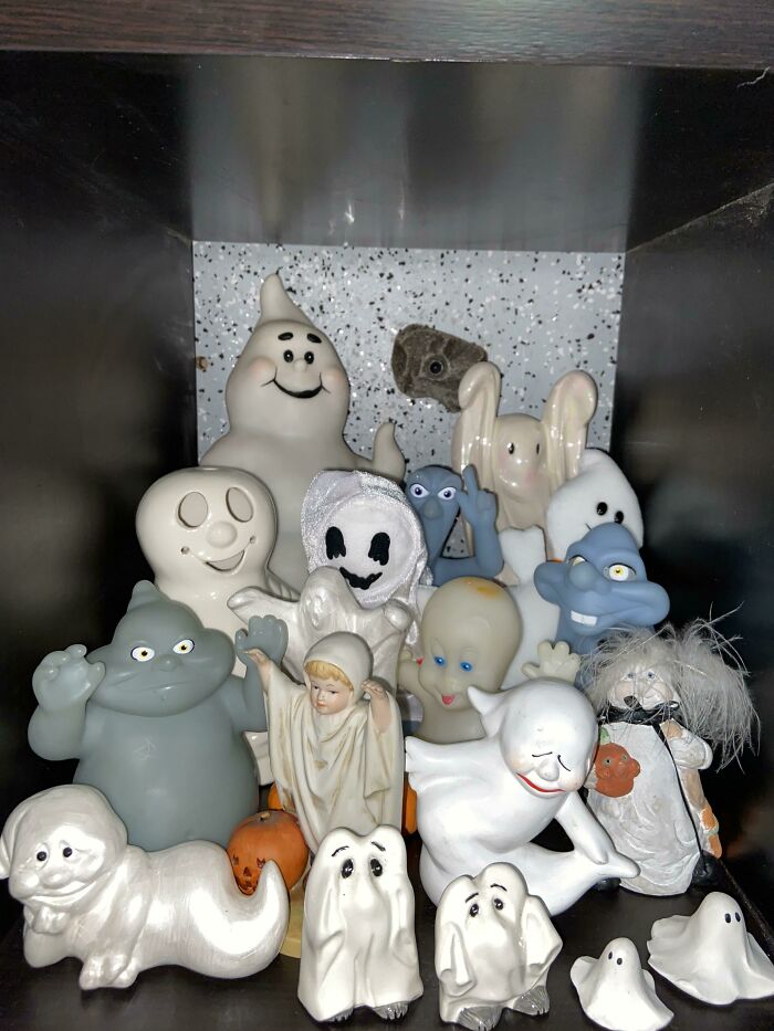 A collection of unique ghost figurines displayed on a shelf, showcasing unexpected designs and characters.