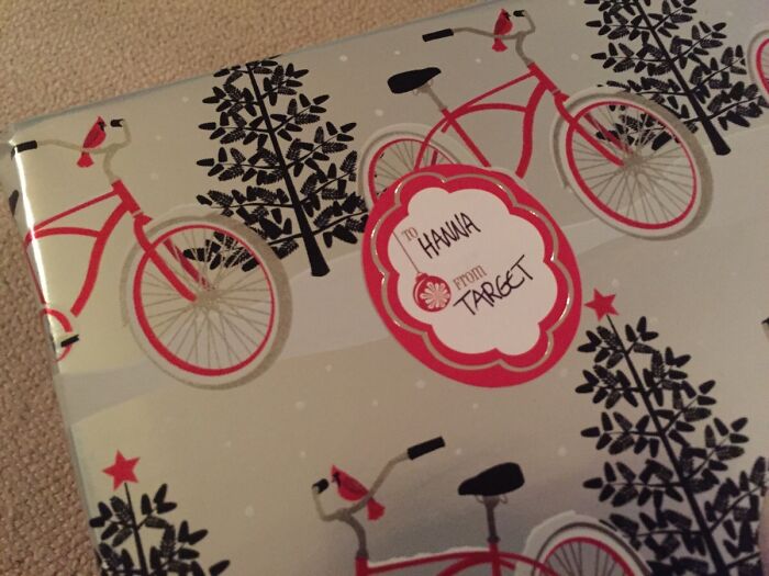 Hilarious trolling Christmas gift wrapped in bicycle-themed paper, addressed "To Hanna from Target."