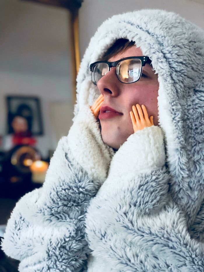 Person in fluffy outfit with tiny hands, a funny Christmas gift idea.