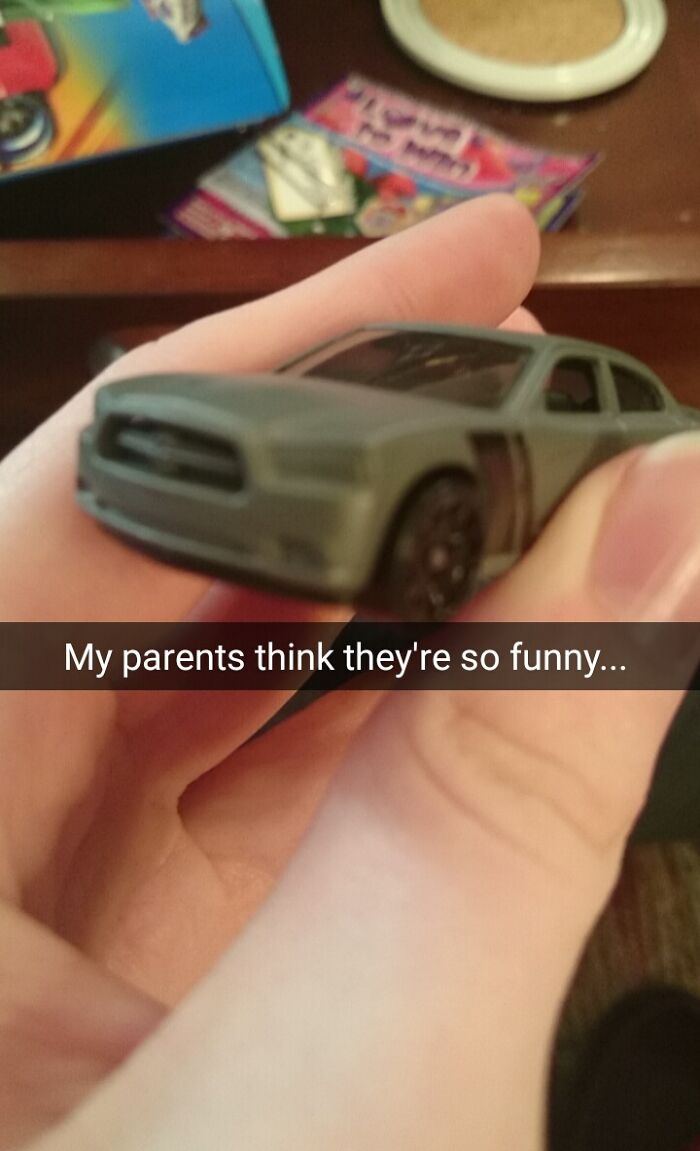 Close-up of a hand holding a toy car, showcasing hilarious trolling Christmas gifts.