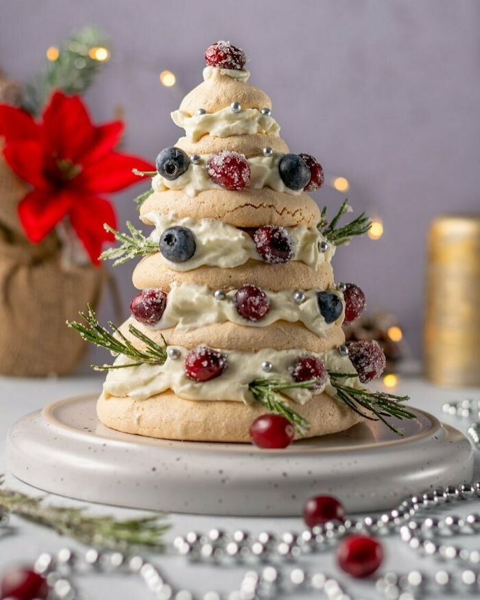 Festive Christmas snack shaped like a tree, decorated with berries and cream, ideal for holiday food ideas.