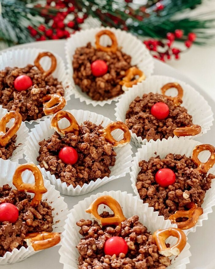 Christmas snack food ideas with chocolate clusters, pretzels, and red candies on a festive plate.