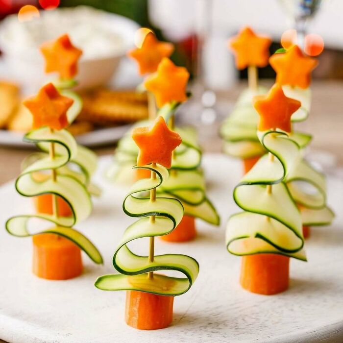 Christmas snack food ideas featuring cucumber and carrot Christmas tree snacks.