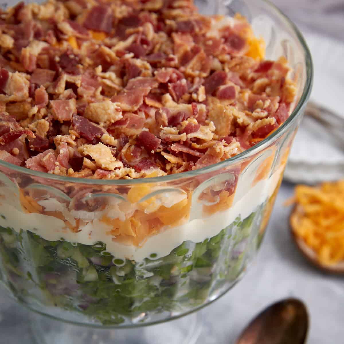 A glass bowl of 7 layer salad.