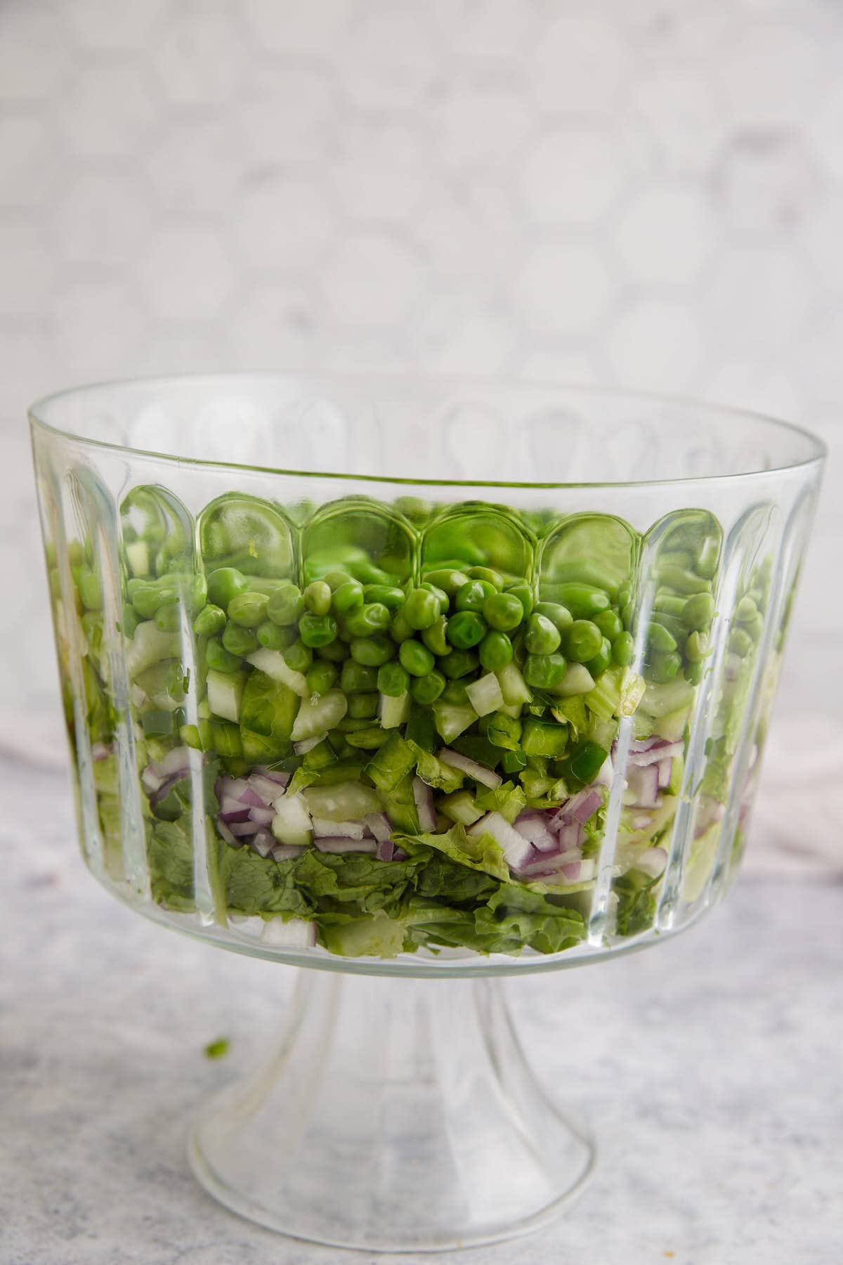 The vegetables layered in a trifle bowl.