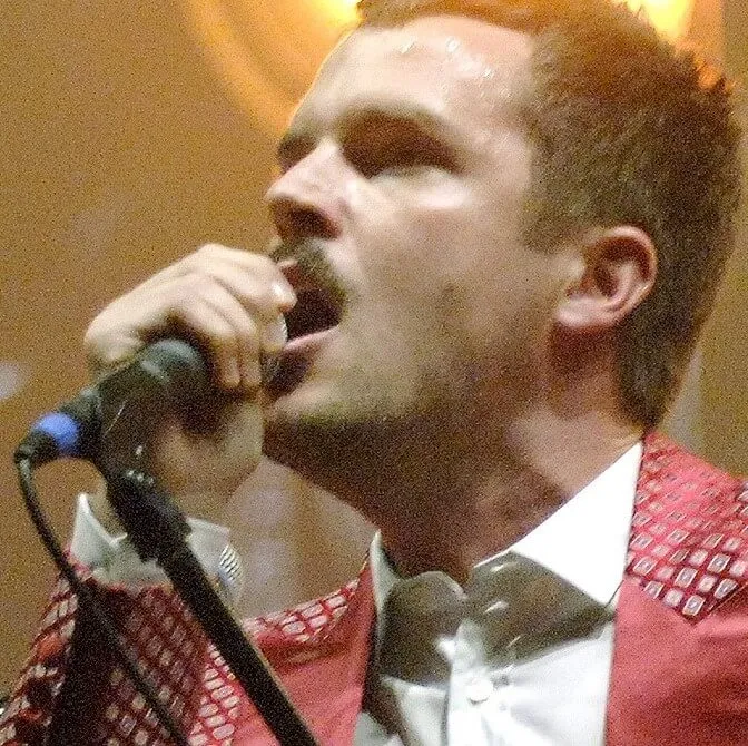 The Killers' Brandon Flowers with a microphone