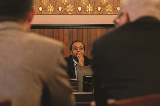 Senate Transportation committee Chair Sen. Ram Villivalam, D-Chicago, watches on as the heads of downstate transit agencies discuss operational issues at a committee hearing.