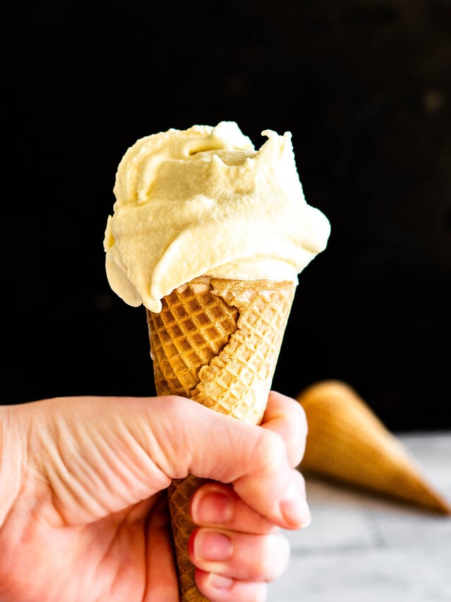 Hand holding a drippy sous vide ice cream cone.