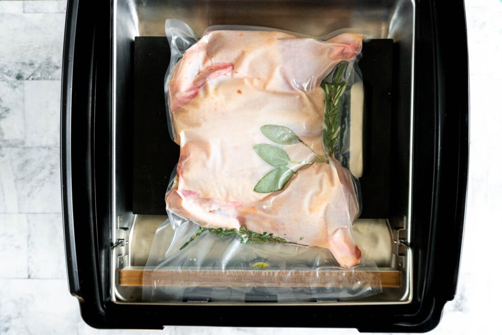 Sealed bag of chicken in chamber vacuum sealer.