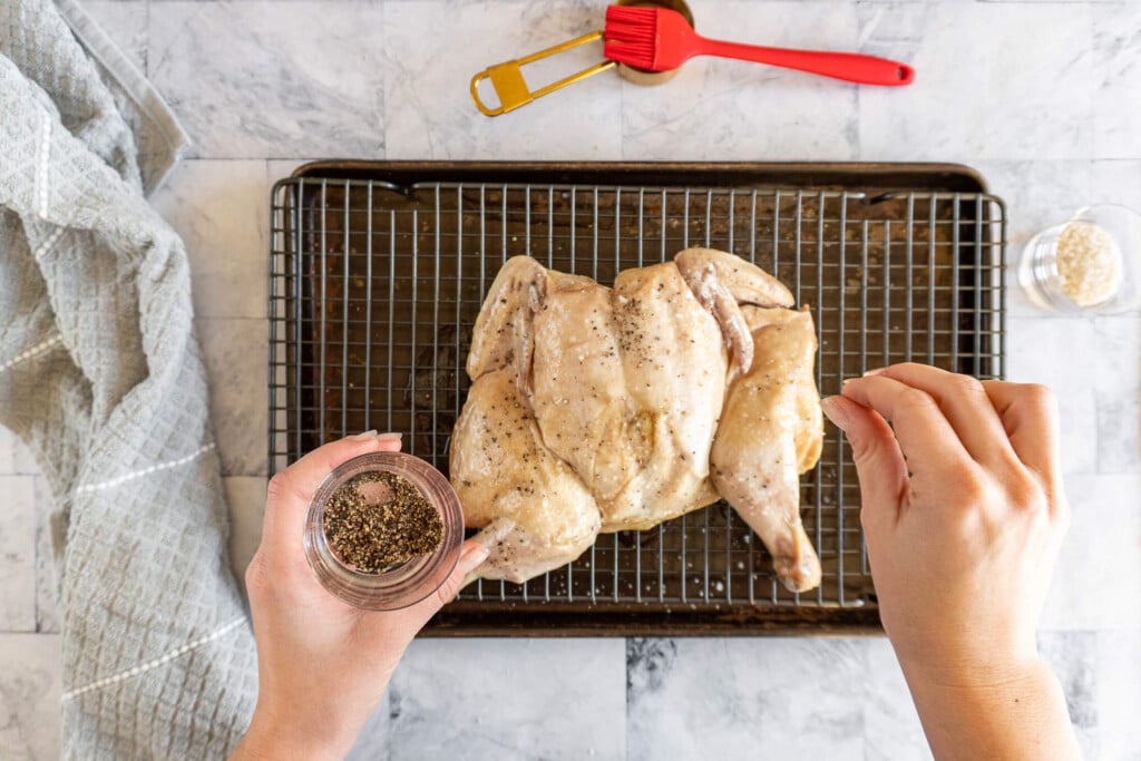 Seasoning chicken with salt and pepper. 