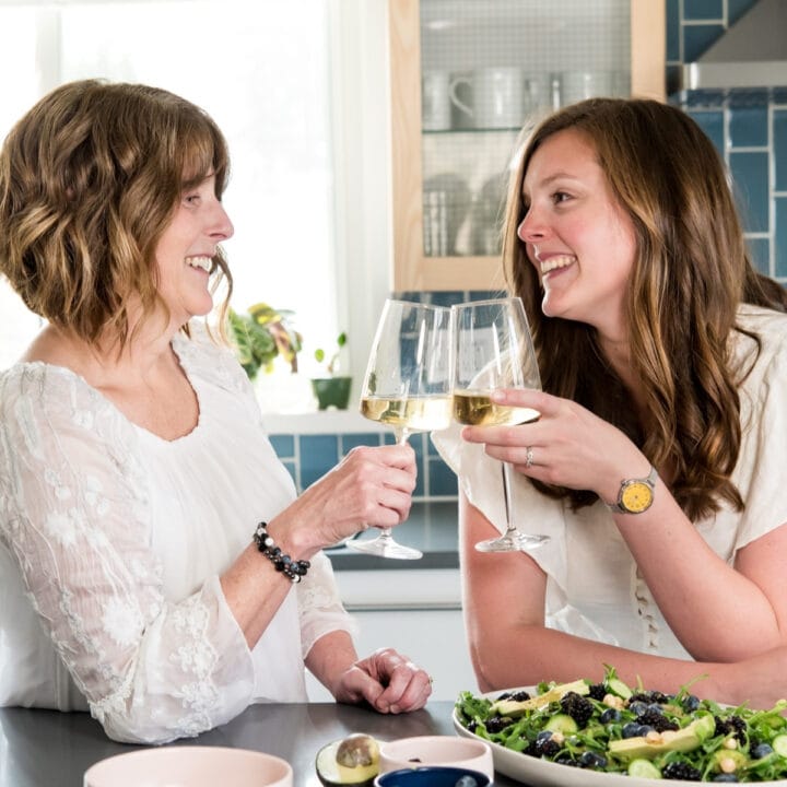 Lexi and Beth toasting with wine.