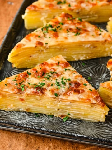 Front view of dauphinoise potatoes cut into triangles.