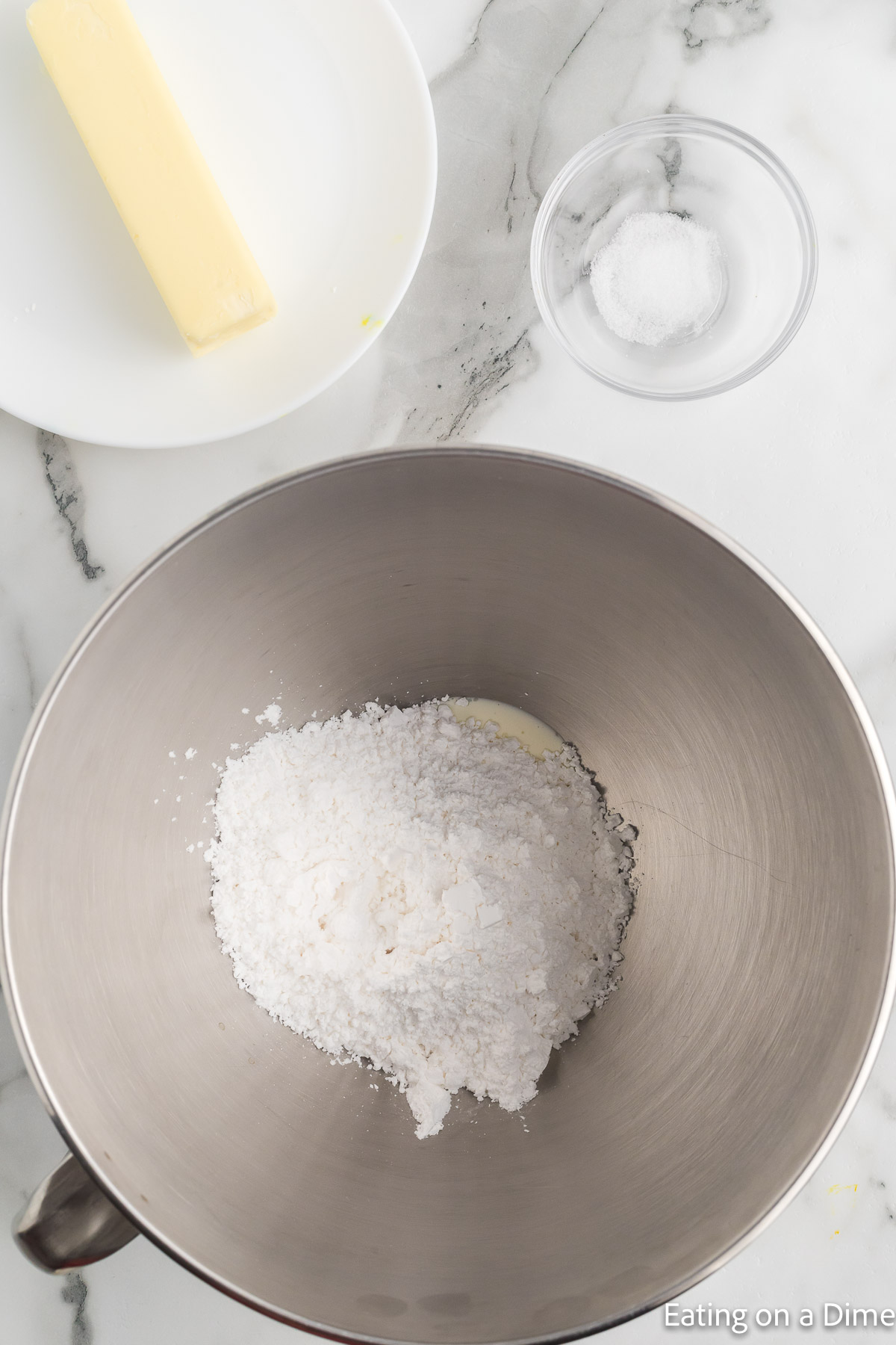 Mixing the heavy cream, salt, extract and powdered sugar together