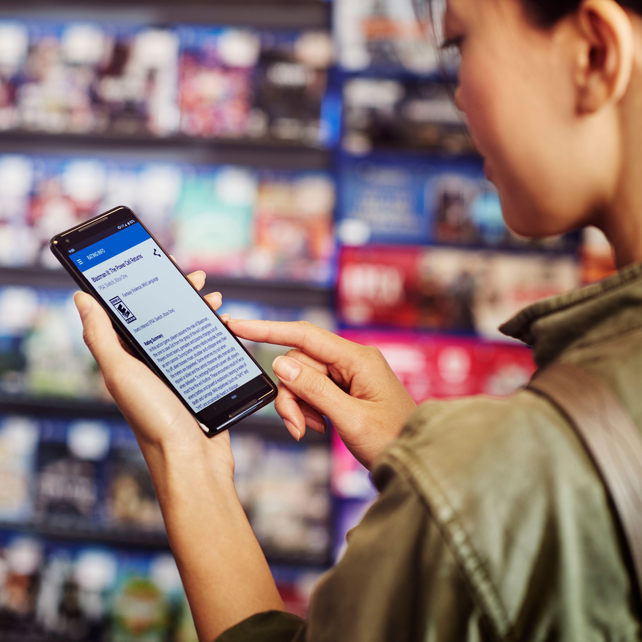 mom holding phone at retail store