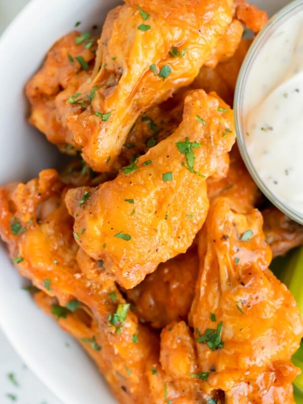 Buffalo chicken wings are served for a low-carb, healthy main dish on a plate.