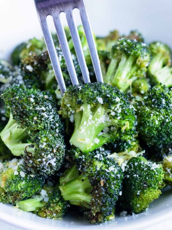 Lemon garlic air fryer broccoli is eaten with a fork.