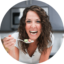 A photo of London Brazil, the author of the food blog Evolving Table, eating a bite of food in her kitchen.