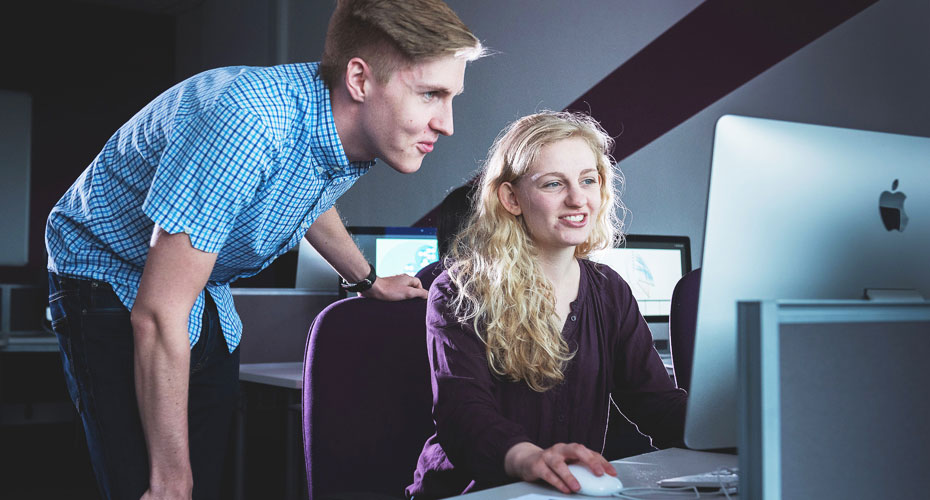 Man and woman looking at computer