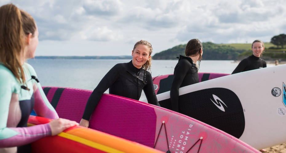 Paddleboarders coming out of sea