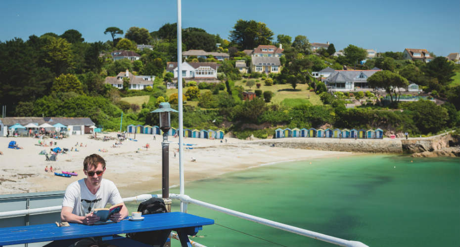 A student reading by the beach