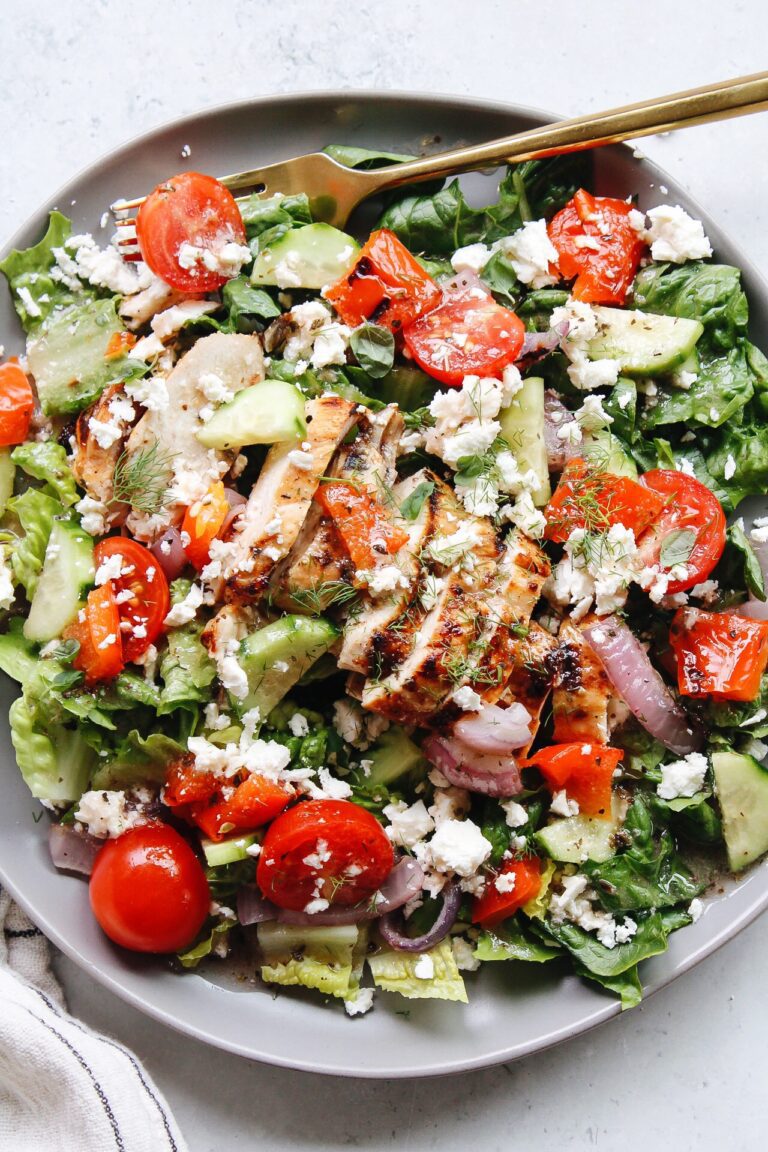 greek grilled chicken salad on a plate with a gold fork