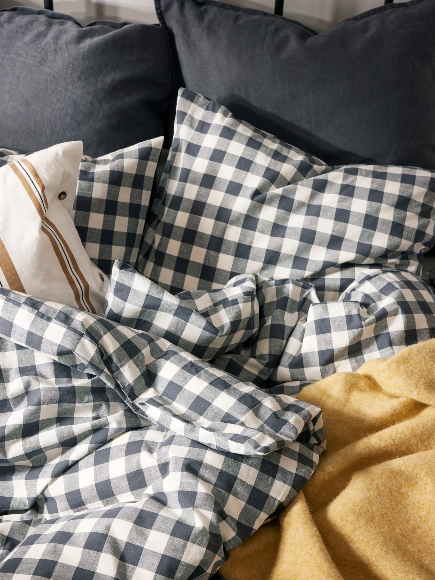 Close up of a bed set with EKTANDVINGE bed linen with an anthracite and white check pattern.