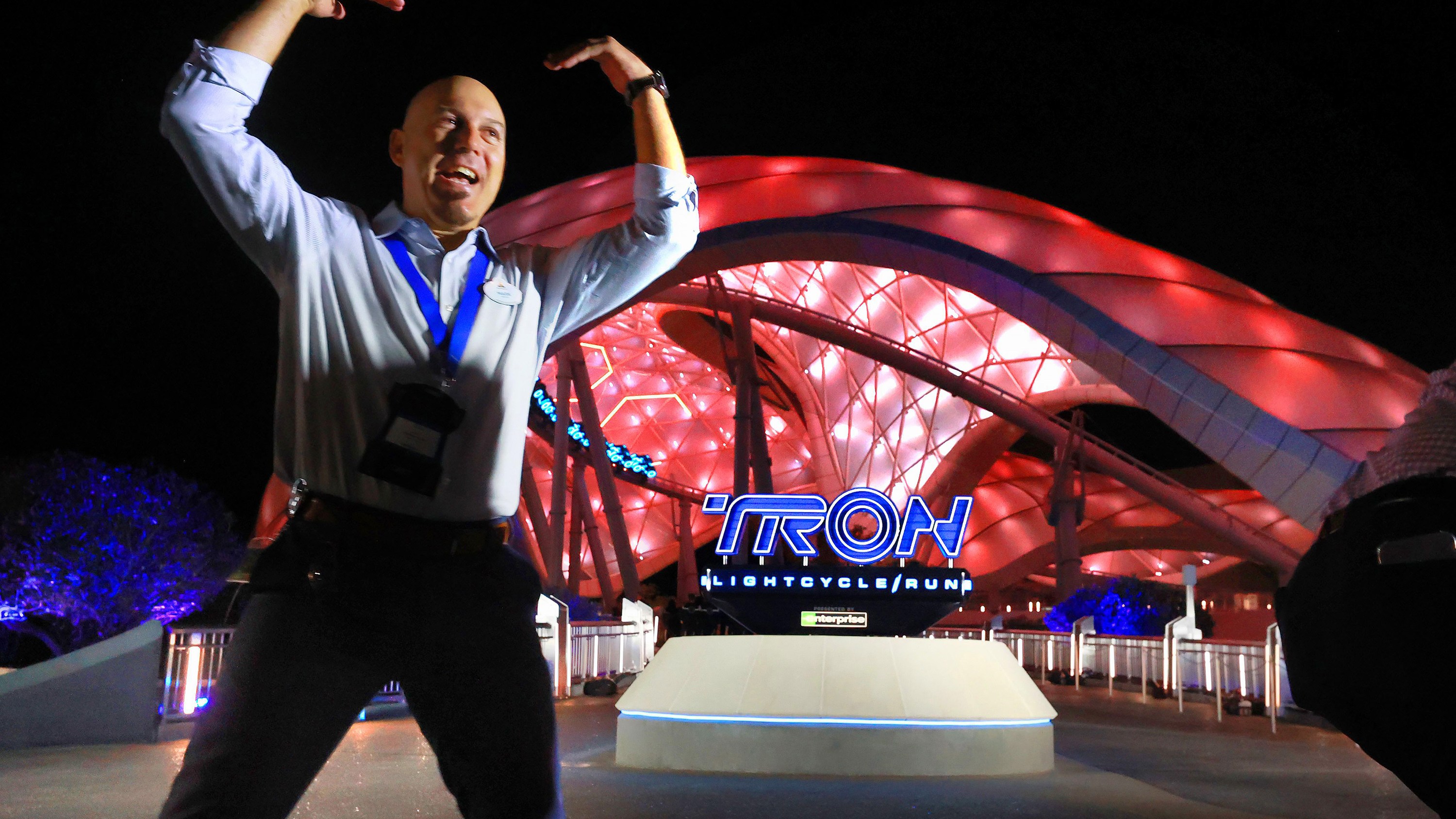 A cast member welcomes guests at the new Tron Lightcycle / Run roller coaster during a preview at the Magic Kingdom at Walt Disney World