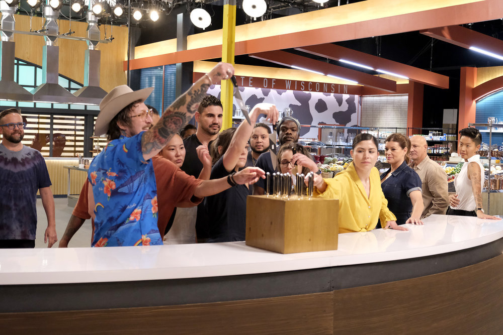 TOP CHEF -- "Chef's Test" Episode 2101 -- Pictured: (l-r) Daniel Jacobs, David Murphy, Kaleena Bliss, Manuel "Manny" Barella Lopez, Savannah Miller, Kenny Nguyen, Charly Pierre, Iisha Elenz, Laura Ozyilmaz, Gail Simmons, Tom Colicchio, Kristen Kish -- (Photo by: David Moir/Bravo)