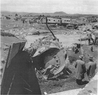 The wreckage of the KA locomotive, the sixth carriage and the rail bridge, in the Whangaehu River at Tangiwai, 25 December 1953.