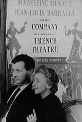 Barrault and Renaud standing in front of a poster for their company