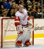 Jimmy Howard on the ice, upright in front of his net