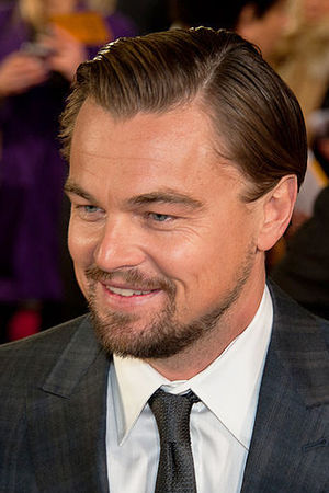 Leonardo DiCaprio is smiling away from the camera.