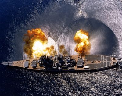 USS Iowa (BB-61) fires a full broadside of nine 16"/50 caliber Mark 7 guns and six 5"/38 caliber guns during a target exercise near Vieques, Puerto Rico on 1 July, 1984. Note concussion effects on the water surface, and 16-inch gun barrels in varying degrees of recoil.