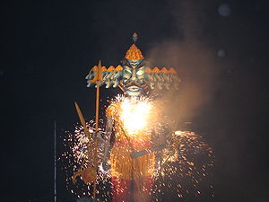 Statue lit up with sparklers at night