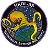 Mission "patch" of NROL-39: an octopus grabbing the earth's globe, labeled "Nothing is beyond our reach"