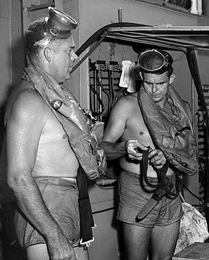 This is a photo of Commander (Medical Corps) George F. Bond and Chief Engineman Cyril Tuckfield after safely completing a 302 foot buoyant ascent in 52 SECONDS from the forward escape trunk of the USS Archerfish bottomed at 322 feet