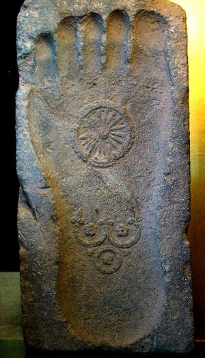 stone footprint Gautama Buddha with Dharmachakra and Three Jewels