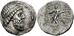 Two sides of a coin. The side on the left showing the head of a bearded man, while the right a standing individual.